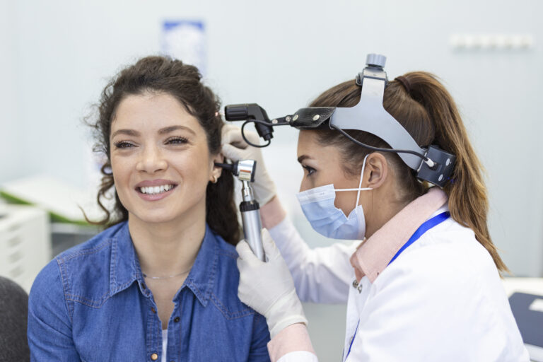 hearing exam otolaryngologist doctor checking woman s ear using otoscope auriscope medical clinic