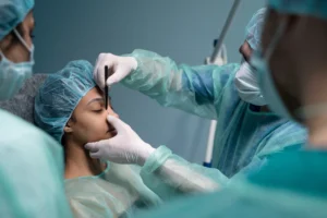 side view doctor checking patient before rhinoplasty
