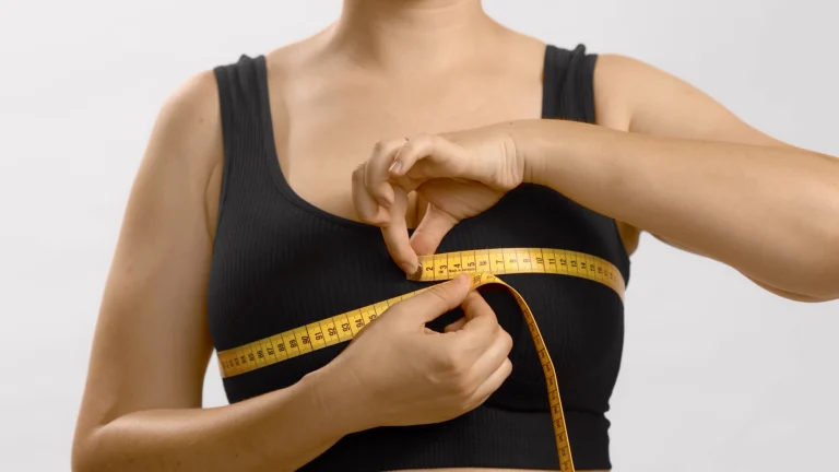 white unrecognizable anonymous lady black top measures her bust with tape bra fitting studio no head 1