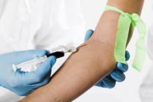 close up doctor taking blood sample from sick person