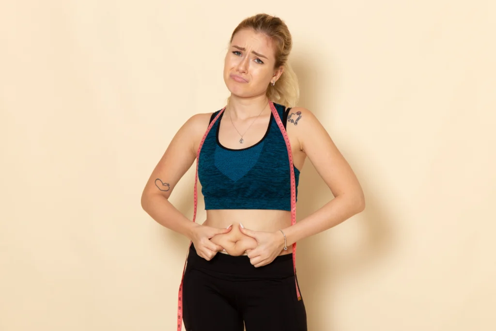 front view young female sport outfit measuring her body 1