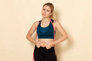 front view young female sport outfit measuring her body 1