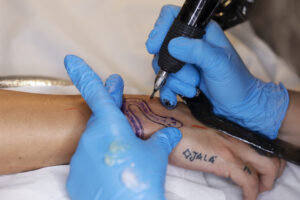 high angle tattoo artist wearing gloves