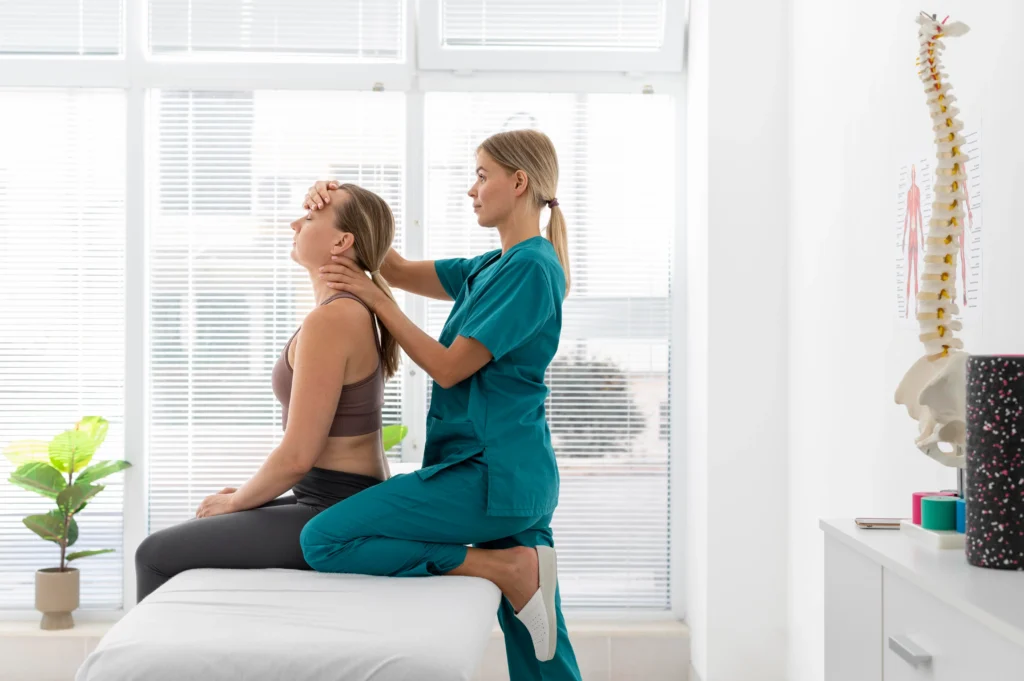 physiotherapist helping patient her clinic