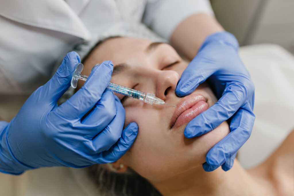 closeup portrait young woman doing botox procedures by professional injection making lips modern devices technology medicine cosmetology therapy