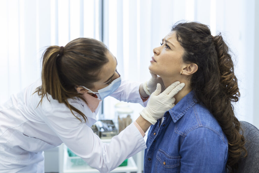 endocrinologist examining throat young woman clinic women with thyroid gland test endocrinology hormones treatment inflammation sore throat