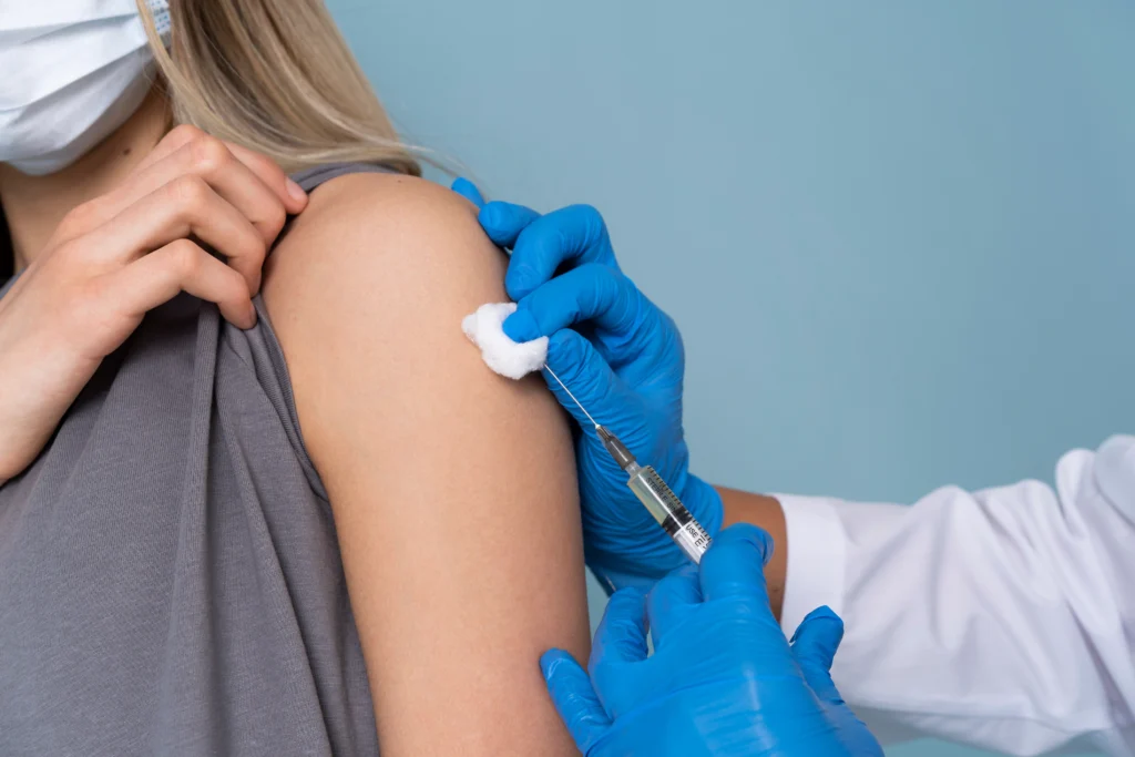 female patient with medical mask getting vaccine