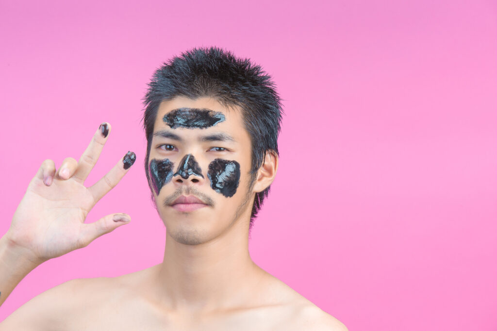 handsome men who apply black cosmetics their faces have pink