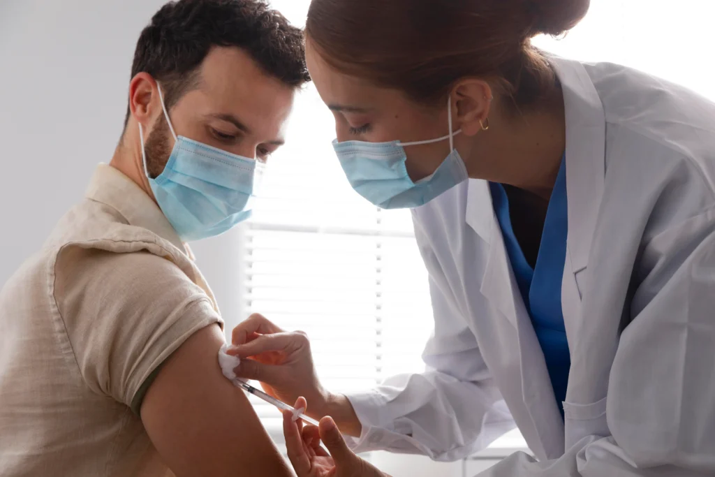 nurse vaccinating male patient